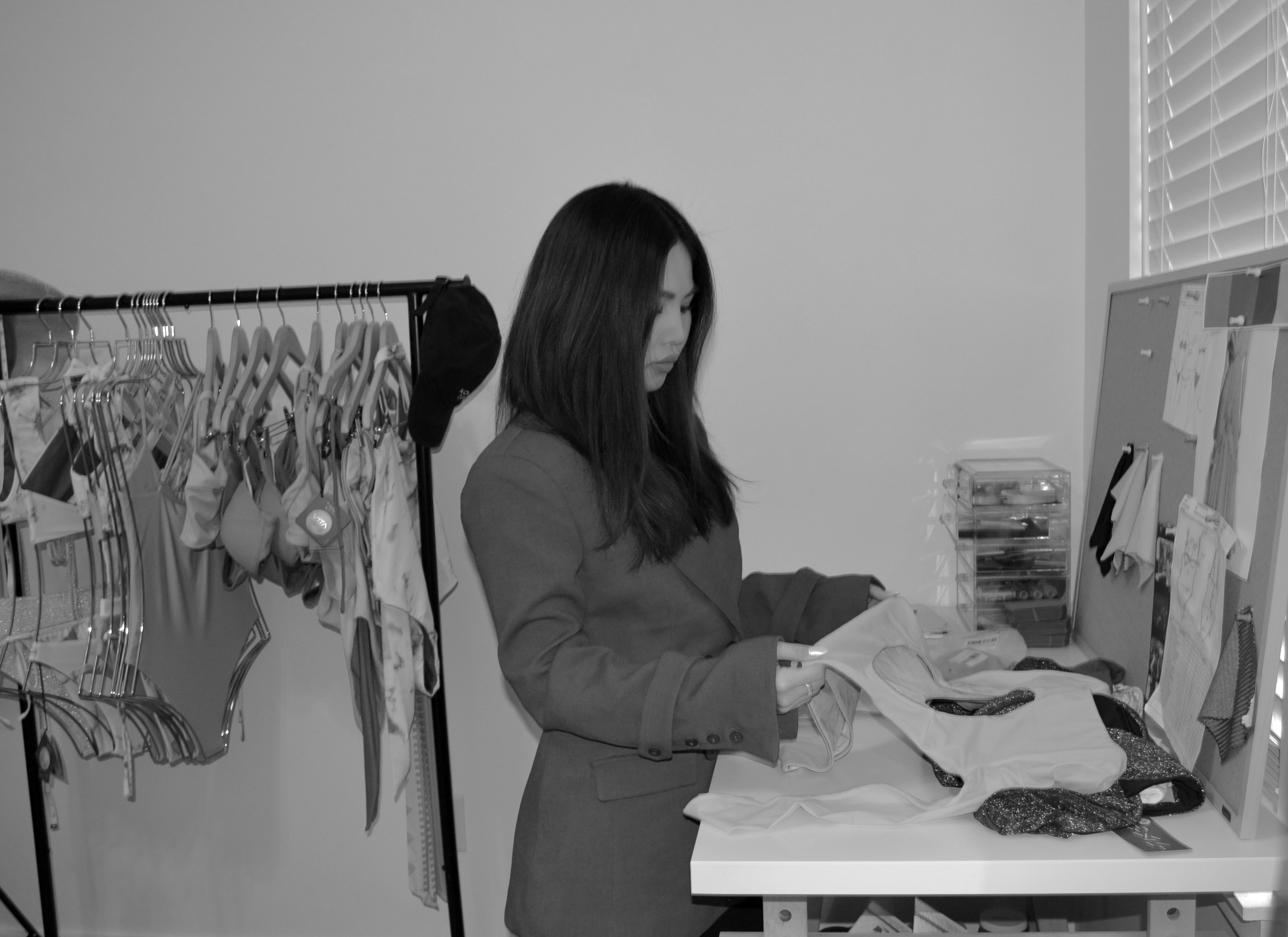 Upcoming business owner at work in sewing shop working on all types of ecofriendly bikinis